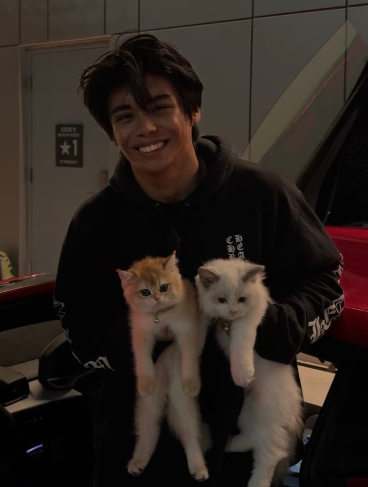 Jeremiah Diana smiling, holding two kittens
